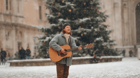 Street musician guitar winter snow holiday outdoor festive joyful performance