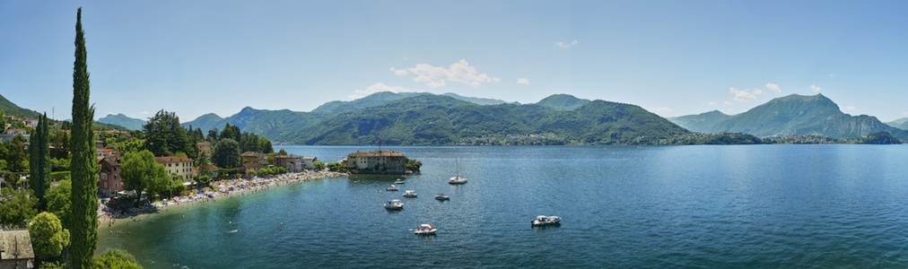 Scenic view of boats on Lake Como with mountains in distance Scenic view of boats on Lake Como with mountains in distance