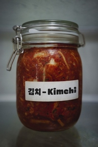 Close up still life shot of kimchi fermenting in glass jar