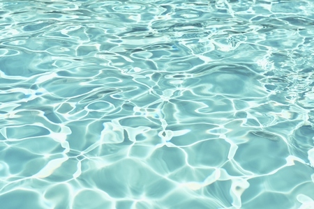 Full frame of sunlight reflecting on rippled turquoise blue surface