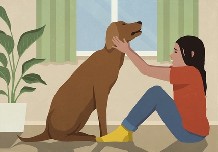 Girl sitting face to face petting dog in living room
