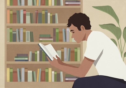 Young man reading book at home by bookcase