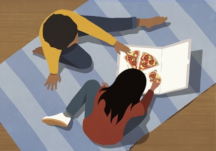 View from above of girl friends eating pizza together on floor