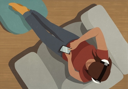 View from above of young woman with headphones and smart phone