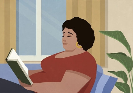 Woman relaxing reading book in living room