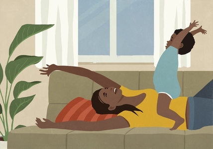 Happy playful mother and toddler son on living room