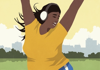 Happy energetic young woman with headphones listening to music and dancing