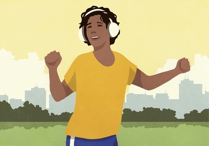 Carefree woman with headphones listening to music and dancing