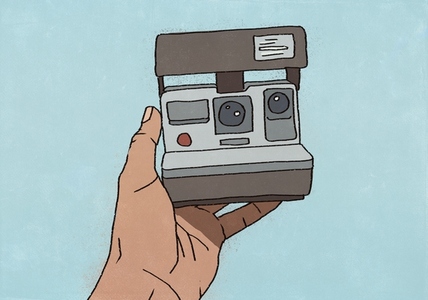 POV hand holding polaroid camera for selfie against blue background