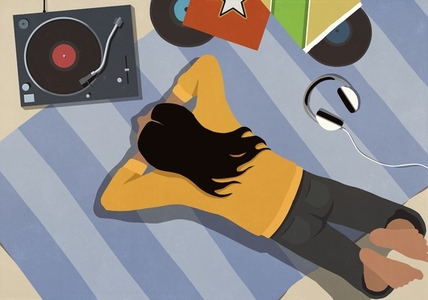 View from above young woman listening to music at record player