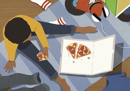 View from above teenage boy eating pizza from box