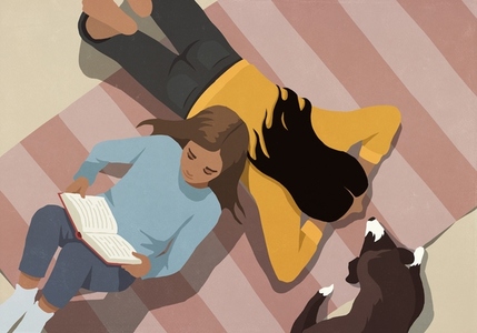 View from above girl reading book on rug by mom and pet dog