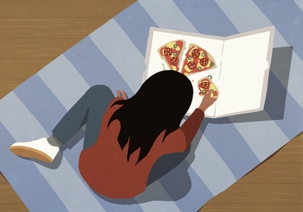 High angle view girl eating pizza on striped rug