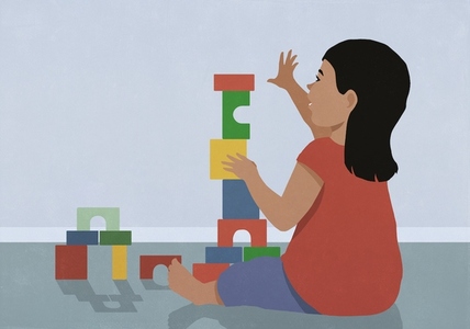 Toddler girl playing stacking toy blocks on floor