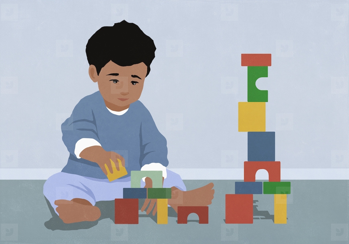 Toddler boy playing stacking toy blocks on floor