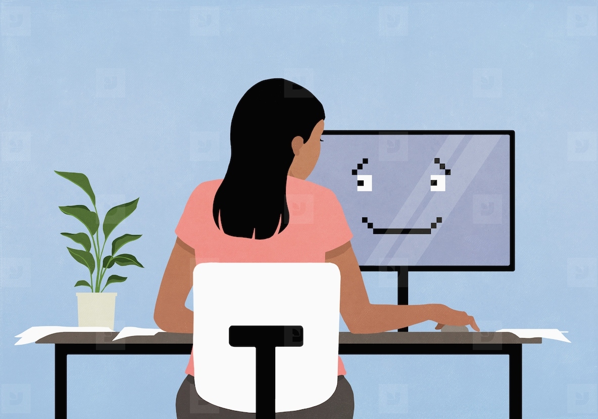 Woman working at computer with smiley face on screen