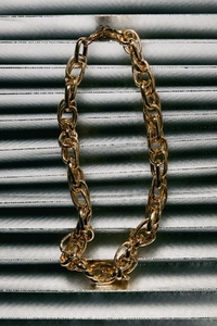 Golden chain necklace on metallic fabric background luxury accessory with elegant texture and stylish modern composition Golden chain necklace on metallic fabric background luxury accessory with elegant texture and stylish modern composition