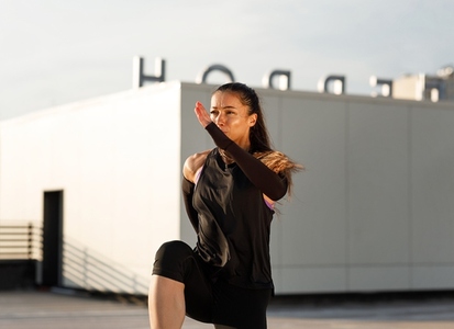 High angle of a slim sportswoman exercising with medicine ball outdoors  Muscular female athlete practicing core workout