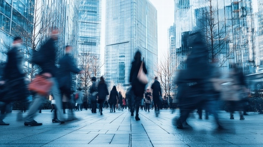 Urban environment with blurred motion of people walking quickly in business district  showcasing dynamic city life