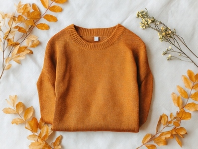 Cozy autumn sweater mockup in warm orange color surrounded by dried leaves and flowers perfect for seasonal fashion Cozy autumn sweater mockup in warm orange color surrounded by dried leaves and flowers perfect for seasonal fashion