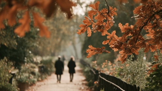 Autumn leaves in park with couples walking creating romantic atmosphere amidst nature beauty Autumn leaves in park with couples walking creating romantic atmosphere amidst nature beauty