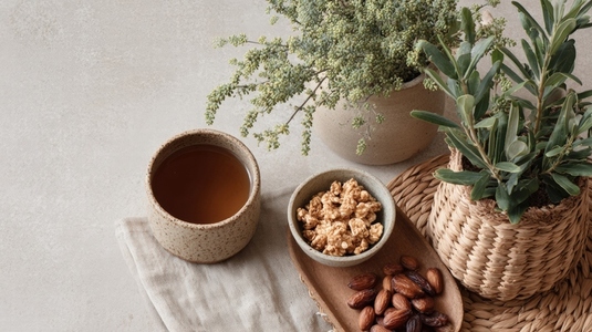 Eco friendly lifestyle flatlay featuring herbal tea  popcorn  dates  and potted plants  creating serene atmosphere
