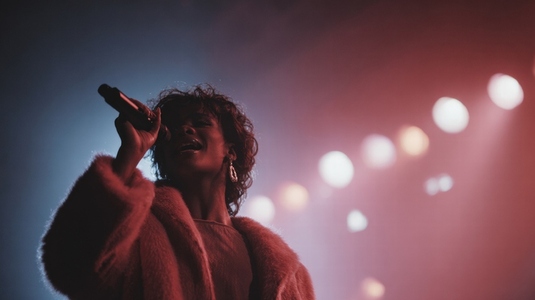 Vibrant performance by singer on stage  showcasing passion and energy under colorful lights