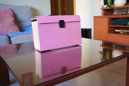 Orderly pastel lounge decor  Refined storage on glossy tabletop surface  Vivid pastel palette complemented by neatly arranged decor items and elegant storage solutions