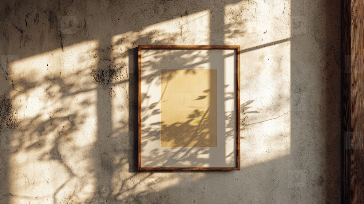 Framed artwork on rustic wall  illuminated by natural light  casting shadows from nearby foliage  creates serene atmosphere