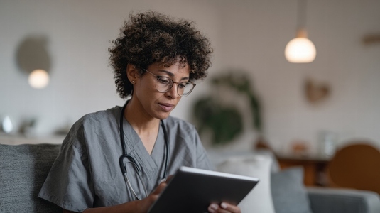 Healthcare professional using tablet for telehealth services cozy home environment showcasing modern medical practices Healthcare professional using tablet for telehealth services cozy home environment showcasing modern medical practices