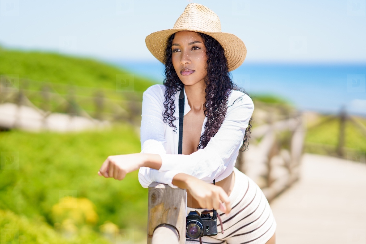 An Elegant Summer Portrait Taken by the Beach Featuring a Camera Capturing Moments