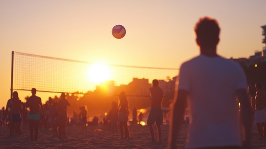 People playing beach volleyball at sunset creating energetic atmosphere People playing beach volleyball at sunset creating energetic atmosphere