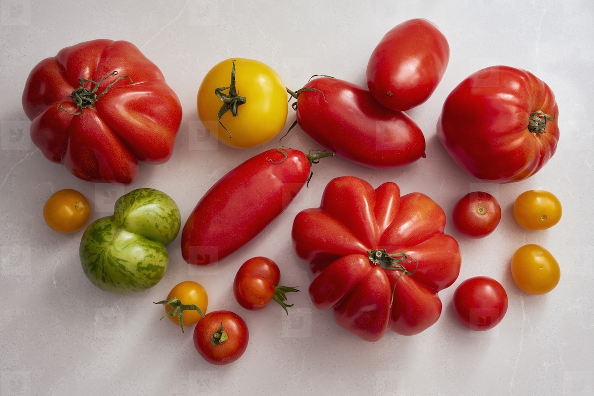View from above variety of heirloom tomatoes on white background
