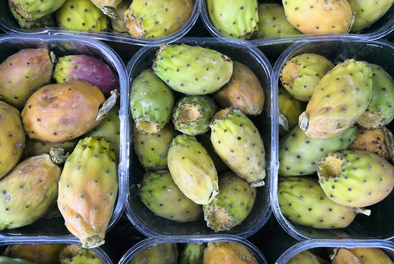Still life view from above of containers of fresh prickly pears