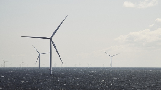 Offshore wind farm wind turbines above surface of ocean Offshore wind farm wind turbines above surface of ocean