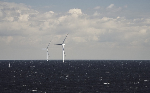 Offshore wind farm wind turbines above surface of ocean Offshore wind farm wind turbines above surface of ocean