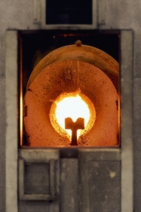 Flame in round opening of hot glassblowing furnace Flame in round opening of hot glassblowing furnace