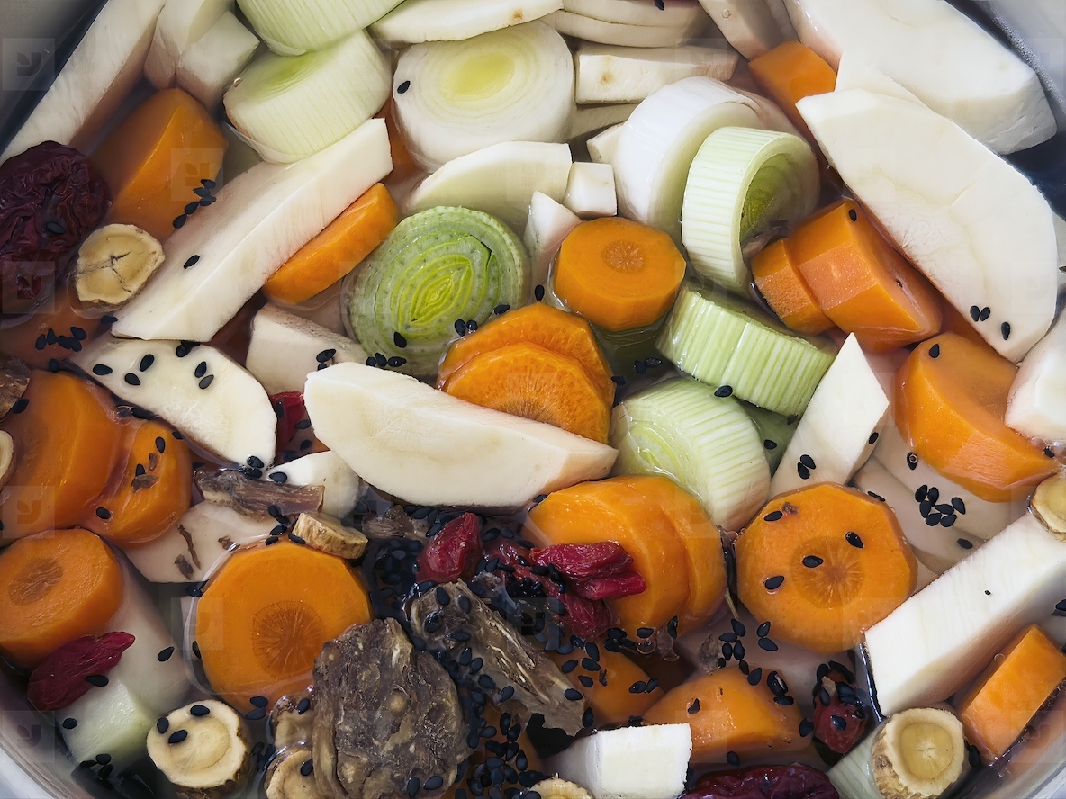 Close up of chopped raw soup ingredient vegetables in pot