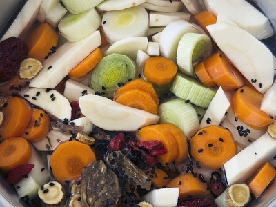 Close up of chopped raw soup ingredient vegetables in pot