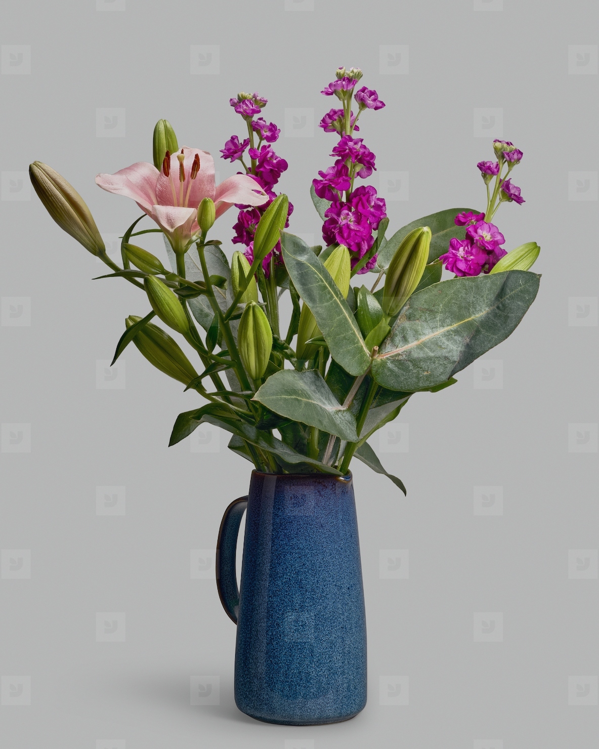 Still life of lily eucalyptus and levkoje bouquet in blue pitcher