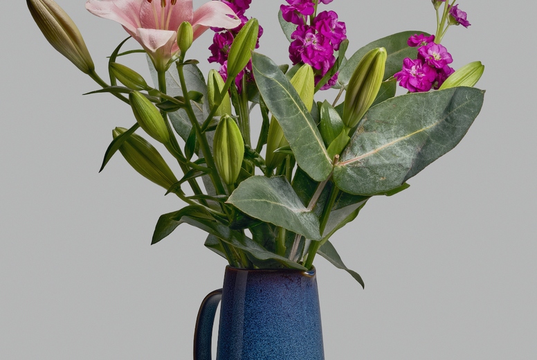 Still life of lily eucalyptus and levkoje bouquet in blue pitcher