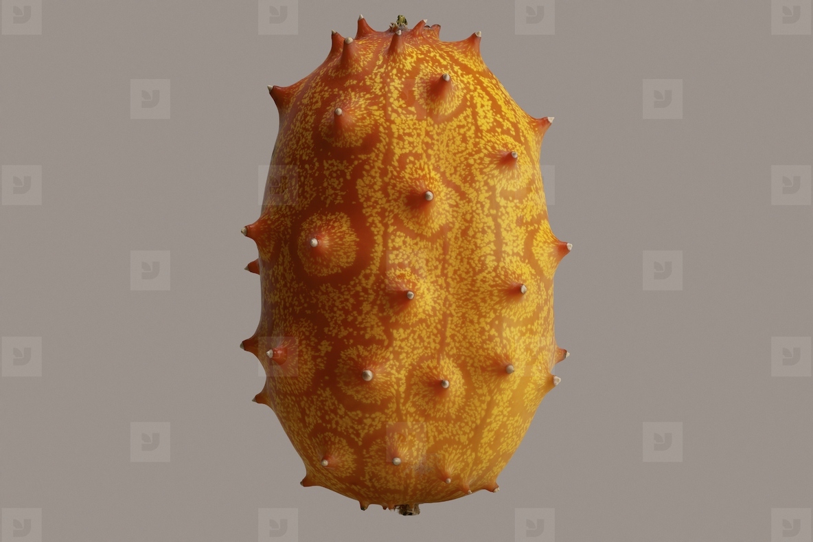 Close up of vibrant yellow and orange horned melon floating