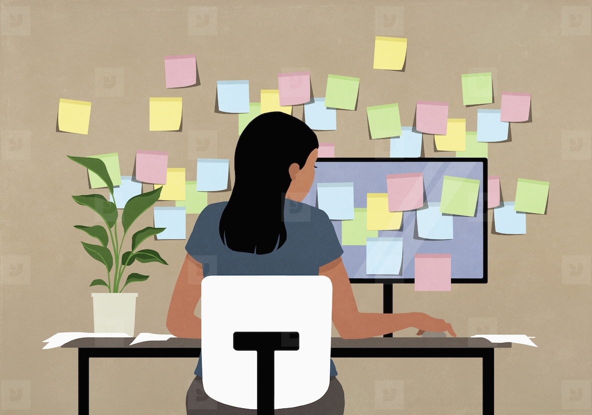 Sticky notes covering computer and wall in front of businesswoman