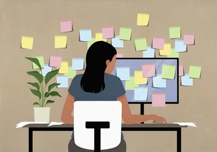 Sticky notes covering computer and wall in front of businesswoman
