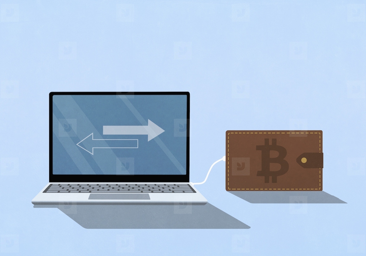 Bitcoin digital wallet plugged into a laptop with arrows on screen