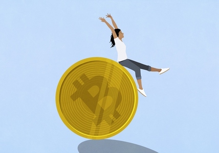 Exhilarated woman riding on top of large gold Bitcoin