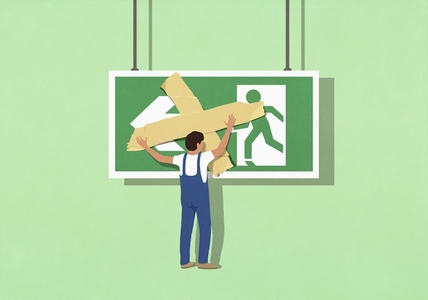 Man in overalls covering large exit sign