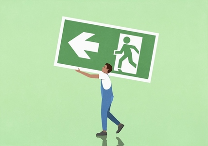 Man in overalls carrying large exit sign