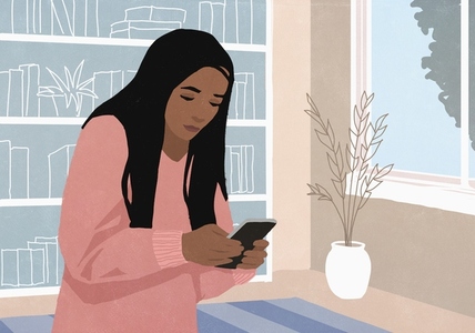 Woman texting with smart phone at home in living room Woman texting with smart phone at home in living room