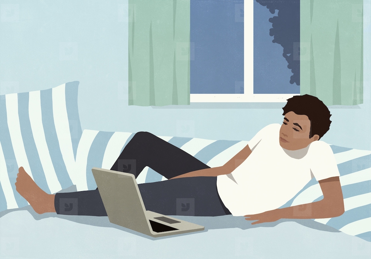 Man relaxing at home on bed at night